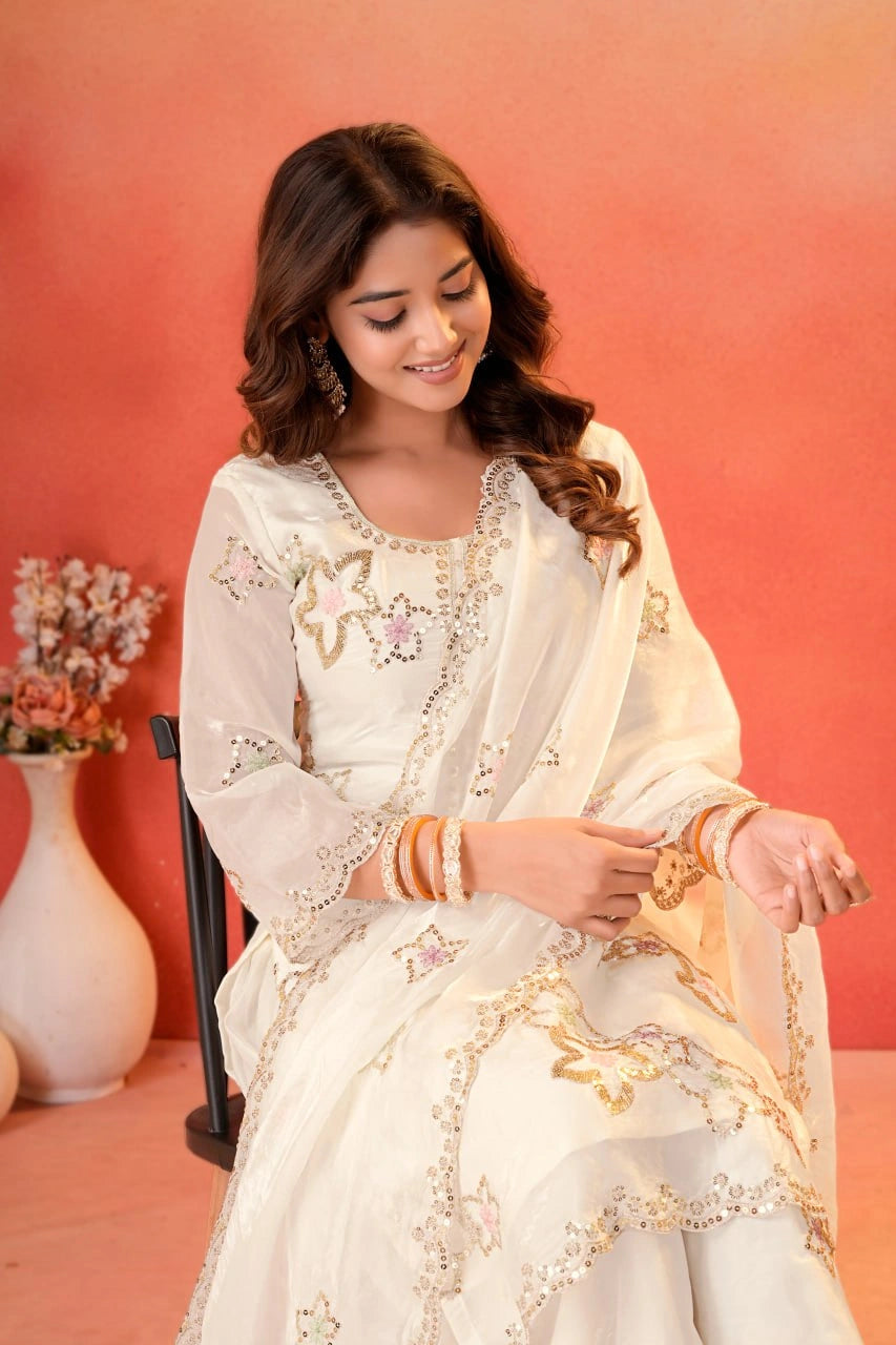 White Sharara Suit seated lifestyle shot showing neckline and upper body embroidery detail