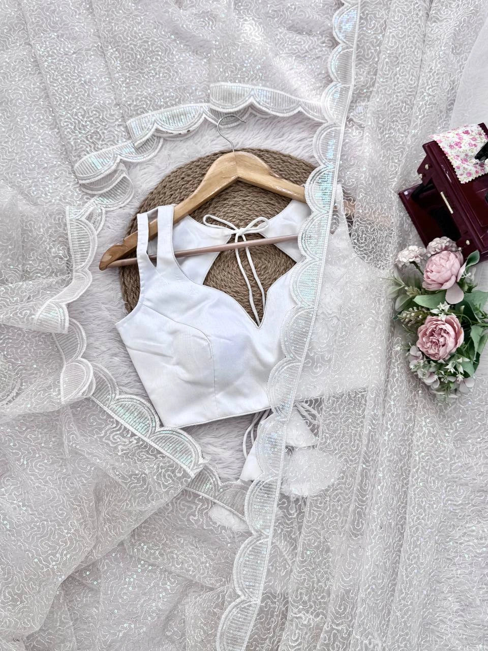 White sequins embroidery detail – flat lay with blouse