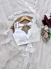 White sequins embroidery detail – flat lay with blouse