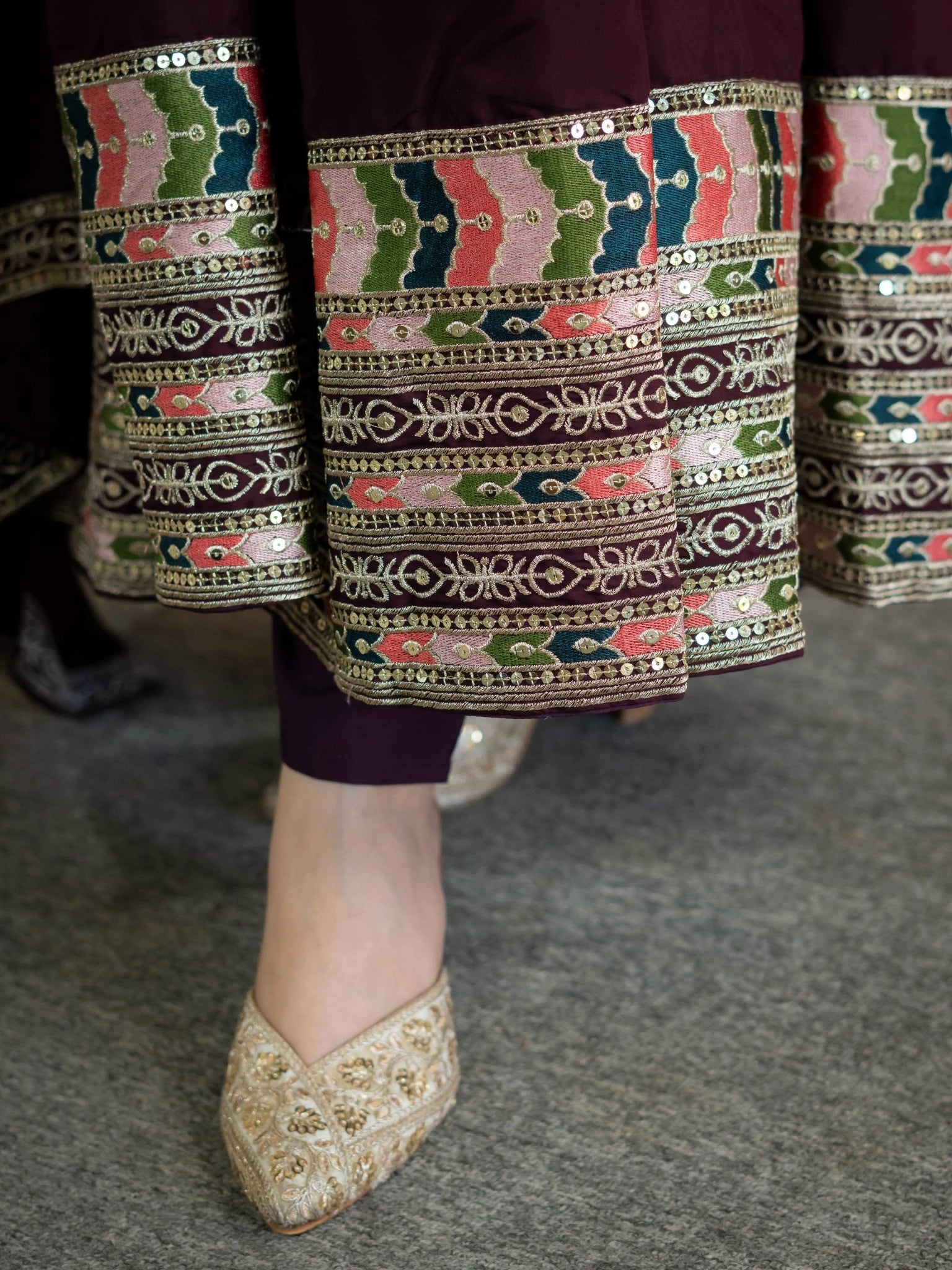 Wine Anarkali Suit hem border close up showing multicolor geometric sequins work