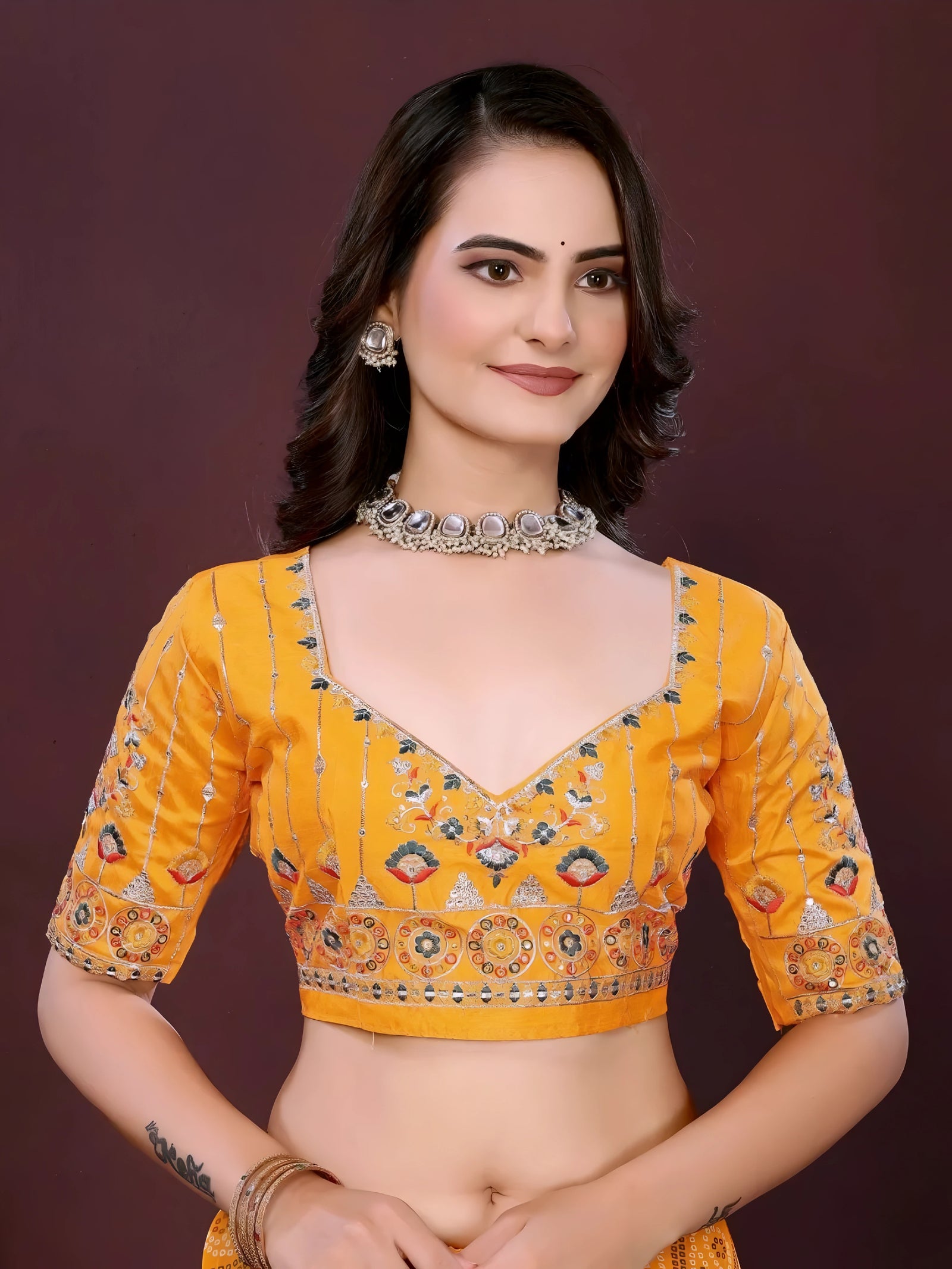 Woman wearing a yellow digital print saree with embroidery work and a contrast patterned border, paired with a matching blouse in an indoor studio product image