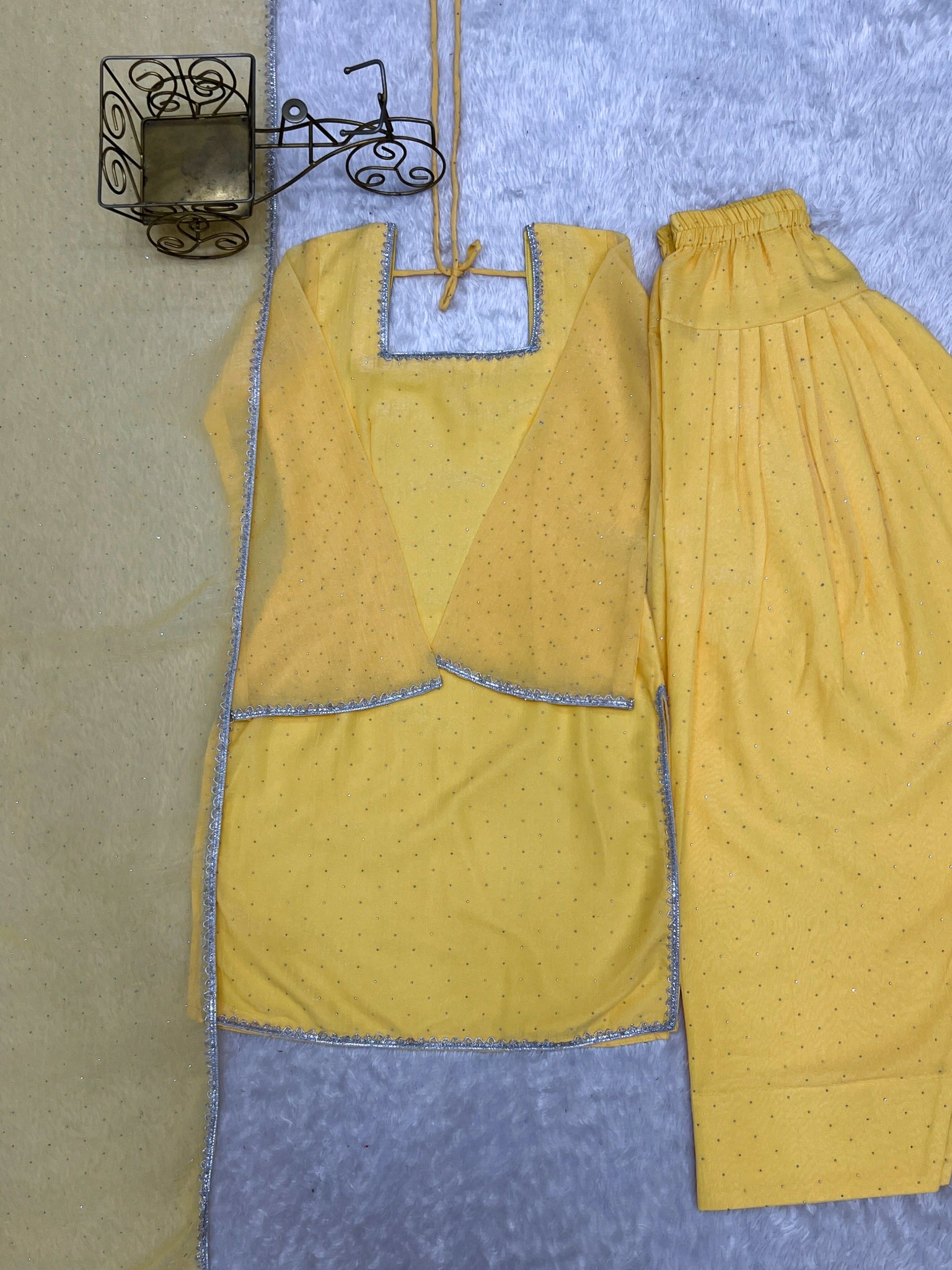 Yellow suit flat lay - lace border detail