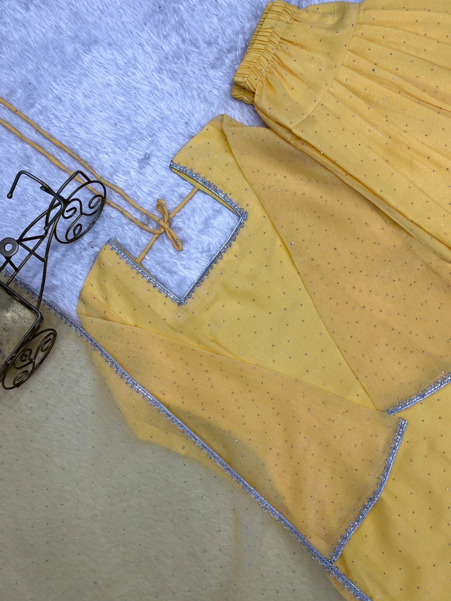Yellow suit flat lay - back tie-up detail
